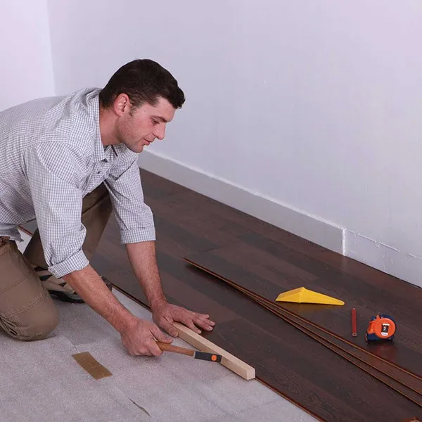 Worker installing laminate | Off-Price Carpet Outlet