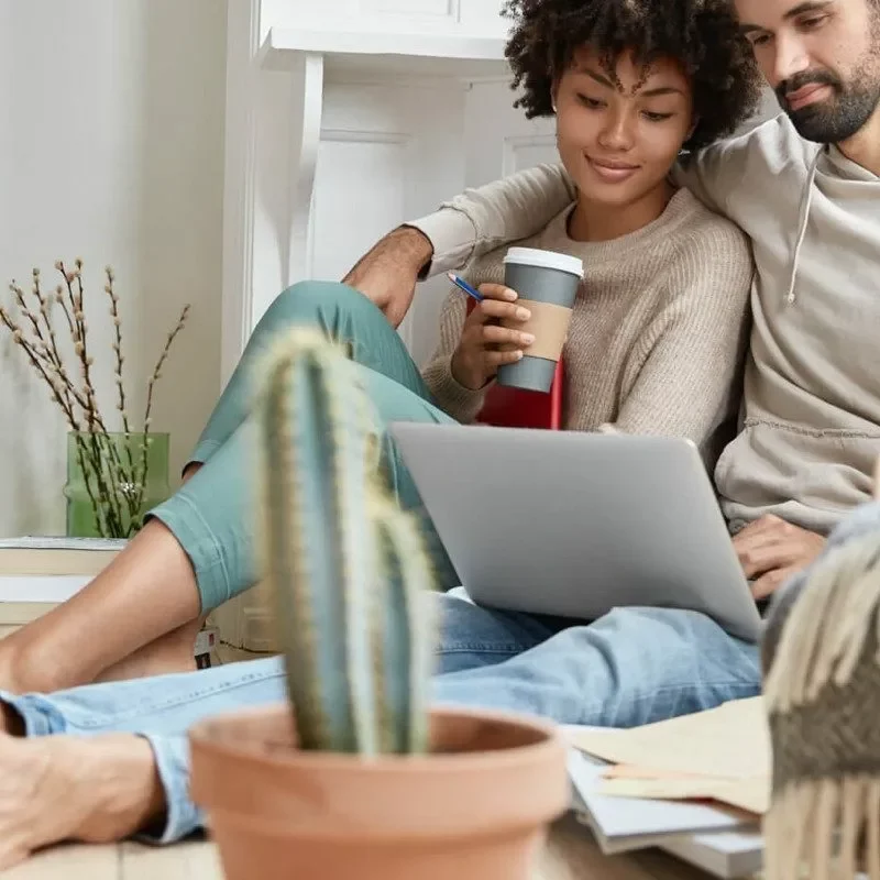 Couple looking into laptop | Off-Price Carpet Outlet